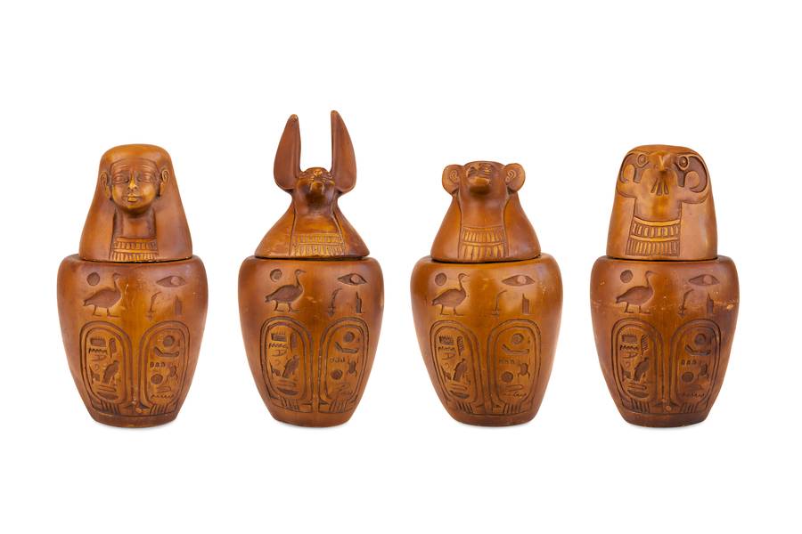 Ancient Egyptian alabaster canopic jars with lids of the Four Sons of Horus