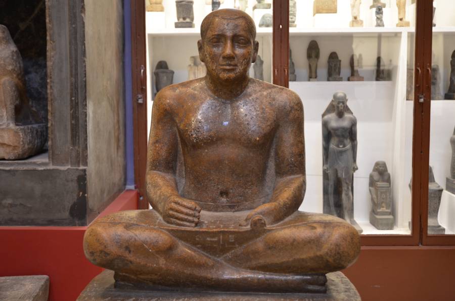 A granite scribe in the Egyptian Museum, Cairo, seated in the working pose.